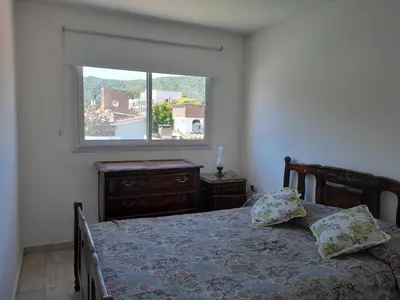 a bedroom with a bed and a window at Fabiana Torres in Villa Carlos Paz