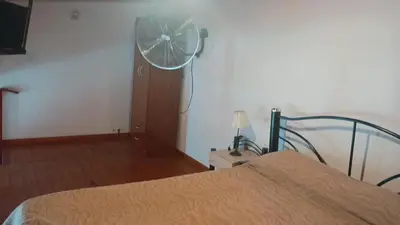 a bedroom with a bed and a fan at Departamento Villa Dolores in San Javier