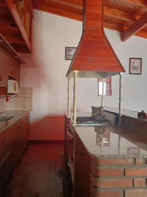 a kitchen with a stove top oven in a room at Departamento Villa Dolores in San Javier