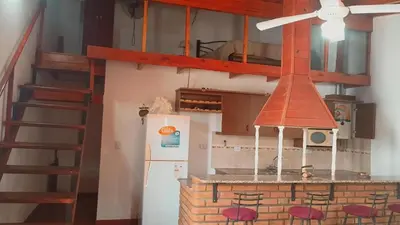 a kitchen with a stove and a refrigerator at Departamento Villa Dolores in San Javier
