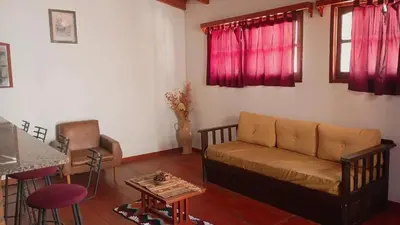 a living room with a couch and a table at Departamento Villa Dolores in San Javier