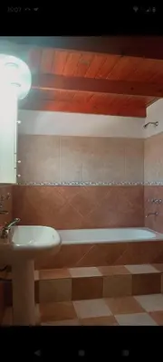 a bathroom with a sink and a bath tub at Departamento Villa Dolores in San Javier