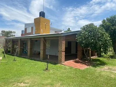 a brick house with a tower on top of it at Complejo los lirios in Villa Los Aromos