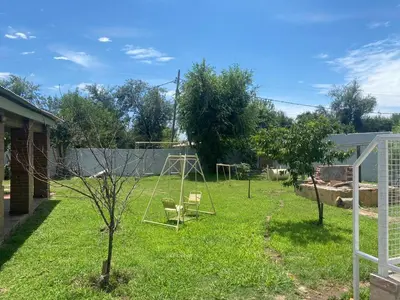 a yard with a swing set in the grass at Complejo los lirios in Villa Los Aromos