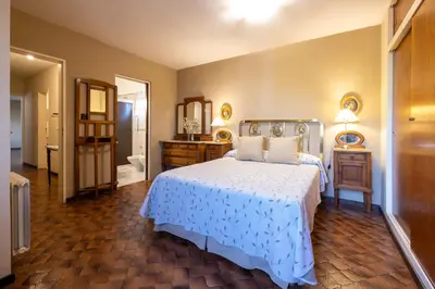 a bedroom with a bed and a bathroom with a mirror at Spacious apartment in a great location near downtown Villa Carlos Paz in Villa Carlos Paz