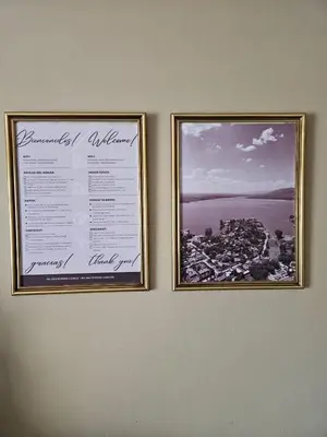 two pictures hanging on a wall with a certificate at Spacious apartment in a great location near downtown Villa Carlos Paz in Villa Carlos Paz