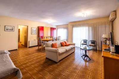 a living room with a couch and a table at Spacious apartment in a great location near downtown Villa Carlos Paz in Villa Carlos Paz