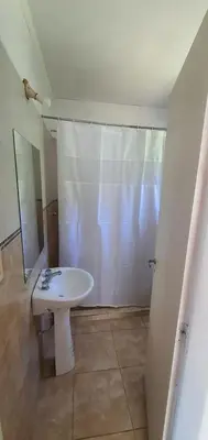 a bathroom with a shower and a white sink at Casa Martina in Villa Rumipal