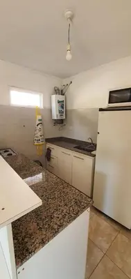 a kitchen with a white refrigerator and granite counter tops at Casa Martina in Villa Rumipal