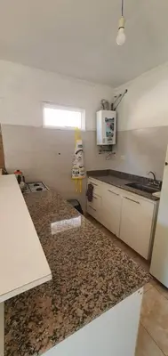 a kitchen with a granite counter top in a room at Casa Martina in Villa Rumipal