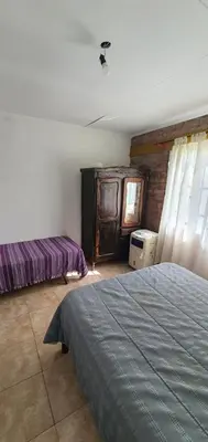 a bedroom with a bed and a dresser in it at Casa Martina in Villa Rumipal
