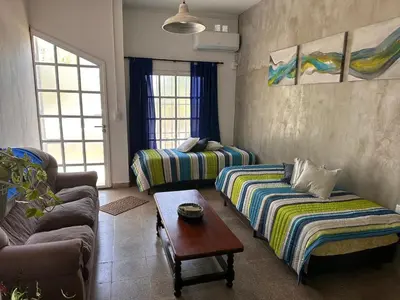 a living room with two couches and a table at Lo de Capretta 2 in Almafuerte