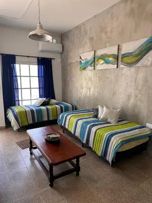 a living room with two beds and a table at Lo de Capretta 2 in Almafuerte