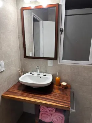 a bathroom with a sink and a mirror at Lo de Capretta 2 in Almafuerte