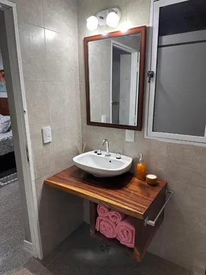 a bathroom with a sink and a mirror at Lo de Capretta 2 in Almafuerte