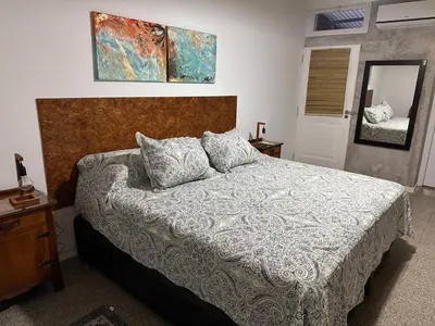 a bedroom with a large bed and a mirror at Lo de Capretta 2 in Almafuerte