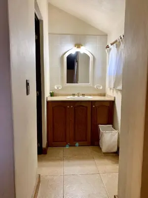 a bathroom with a sink and a mirror at casa vista al lago in Villa Carlos Paz