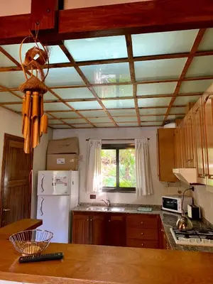 a kitchen with a white refrigerator and a window at casa vista al lago in Villa Carlos Paz
