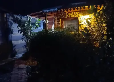 a house at night with a light on the door at Cabaña Té para Tres en Merlo San Luis in Merlo