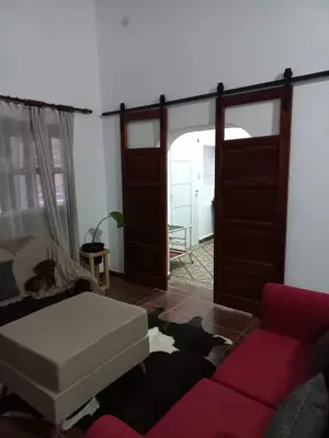 a living room with a couch and an open door at Yuncasuma in Tanti