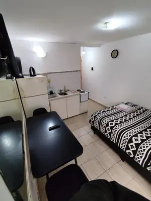 a room with a bed and a desk in it at Rondeau Studios Apartaments in Cordoba