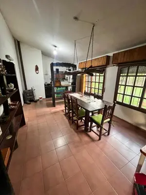 a kitchen with a table and chairs in a room at Mar y Sierras in La Paz