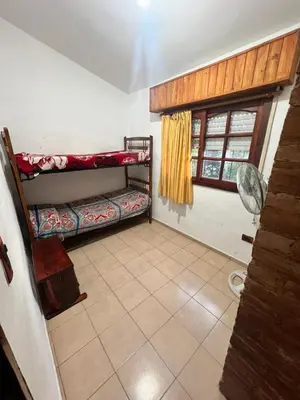 a room with two bunk beds and a window at Mar y Sierras in La Paz