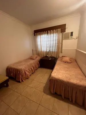 a room with two beds and a window at Santa Rita Dpto in Villa Carlos Paz