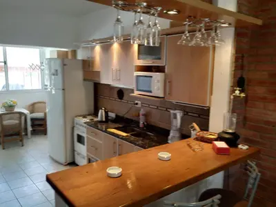 a kitchen with a wooden counter top in a room at Santa Rita Dpto in Villa Carlos Paz