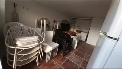 a room with white chairs and a mirror at Villa Gesell Diego Sarmiento in Villa Carlos Paz