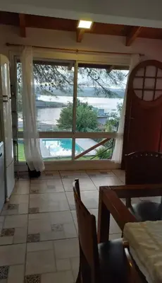 a kitchen with a large window with a view of the water at Villa Gesell Diego Sarmiento in Villa Carlos Paz