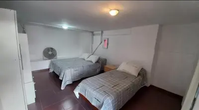 a bedroom with two beds in a room at Villa Gesell Diego Sarmiento in Villa Carlos Paz