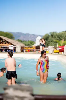 a group of people in the water at a beach at Pipperland Hospedaje in Villa García