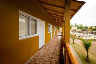 a building with a brick walkway next to a window at Pipperland Hospedaje in Villa García