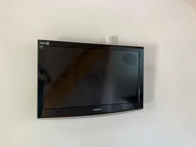 a flat screen tv hanging on a wall at Cabañas Onírico - Duplex in Mina Clavero