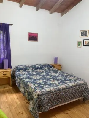 a bedroom with a bed in a room at Cabañas Onírico - Duplex in Mina Clavero