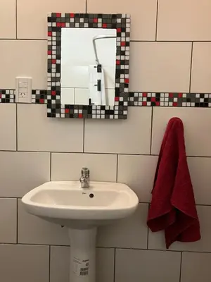 a bathroom with a sink and a mirror at Cabañas Onírico - Duplex in Mina Clavero