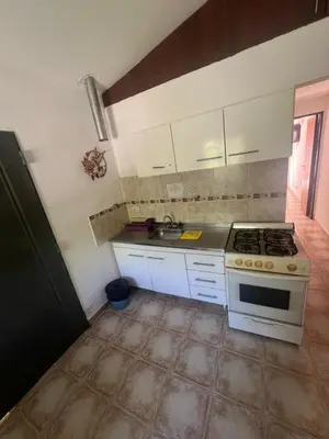 a kitchen with a stove and a sink at Depto para 4 personas con pileta a 3 cuadras del rio in Villa Carlos Paz