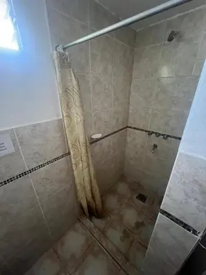 a shower with a shower curtain in a bathroom at Depto para 4 personas con pileta a 3 cuadras del rio in Villa Carlos Paz