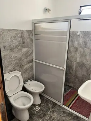 a bathroom with a toilet and a sink at Crisol departamento in Alta Gracia
