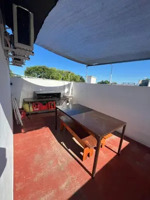 a table on the balcony of a house at Crisol departamento in Alta Gracia