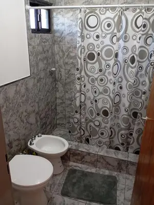 a bathroom with a toilet and a shower at Los Espinillos in Villa Yacanto