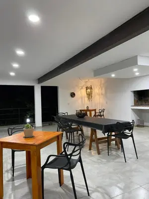 a dining room with a table and chairs at Altos del Oeste in Villa Carlos Paz