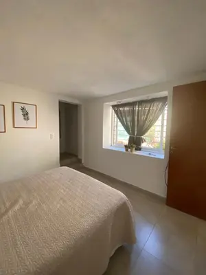 a bedroom with a bed and a window at Altos del Oeste in Villa Carlos Paz