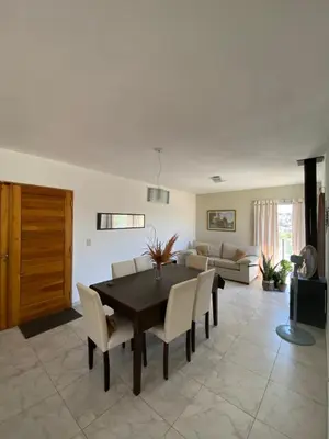 a living room with a table and chairs and a couch at Altos del Oeste in Villa Carlos Paz