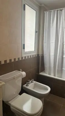 a bathroom with a toilet and a sink and a window at San Lorenzo - Nueva Córdoba in Cordoba