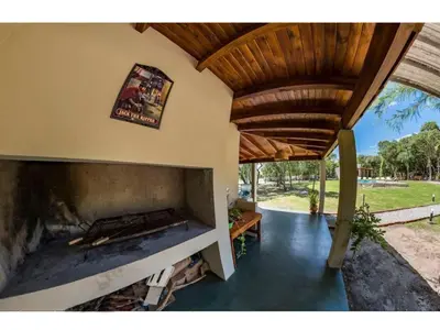 a large fireplace in a house with a wooden ceiling at Las Chuncas Posada Chill Villa de las Rosas in Villa de Las Rosas