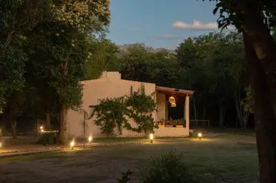 a small white building with lights in a yard at Las Chuncas Posada Chill Villa de las Rosas in Villa de Las Rosas