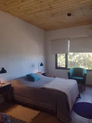 a bedroom with a bed and a desk and a window at 
