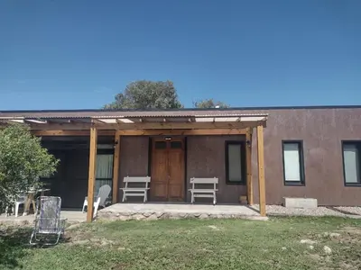 a house with a porch with chairs on it at 